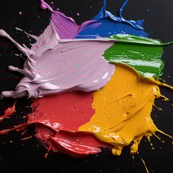 Abstract colorful paint splatters on black background photo