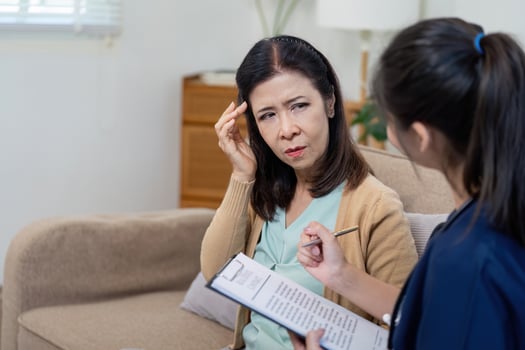 Caregiver checks symptoms of elderly patient with doctor in nursing environment close up view health assessment concept photo
