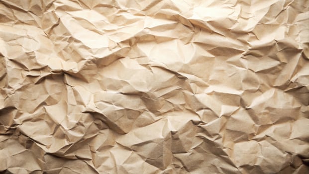 crumpled brown kraft paper texture with natural folds and creases, ideal for eco-friendly packaging, craft design, backgrounds, or rustic aesthetics photo
