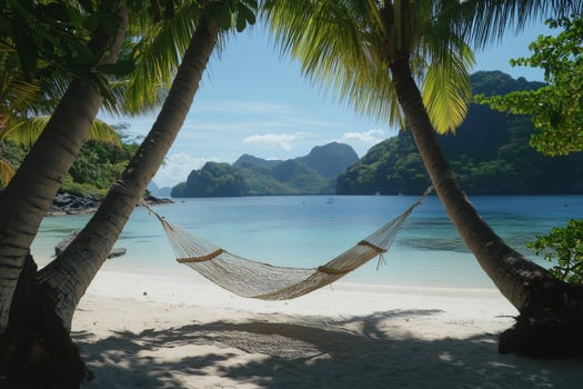 Hammock hanging between palm trees on tropical beach in el nido, palawan, philippines photo