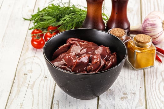 A bowl of meat and spices on a table photo