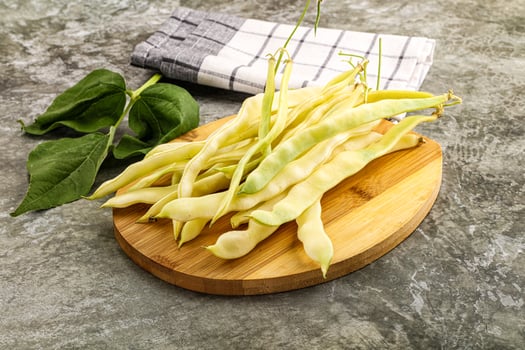 A bunch of beans on a wooden cutting board photo