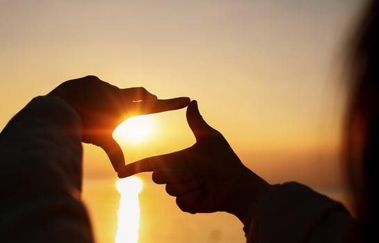 Planning and vision, Woman's Hands making frame looking find focus at sunset. photo