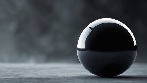Large black sphere is in the middle of a dark background.Large black sphere is in the middle of a dark background. photo