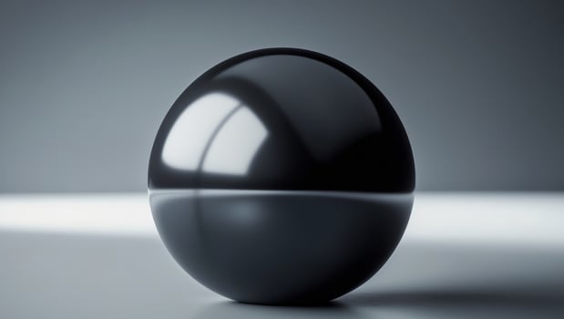 Large black sphere is in the middle of a dark background. photo