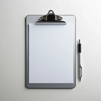 A clipboard with a pen and paper on a white surface photo