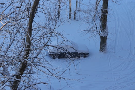 A Stunning SnowCovered Car in a Beautiful Winter Landscape Under a Clear Blue Sky photo