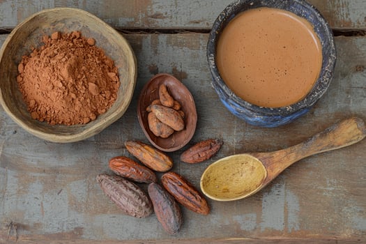 Cocoa powder, cocoa beans, and cocoa beans on a wooden table photo