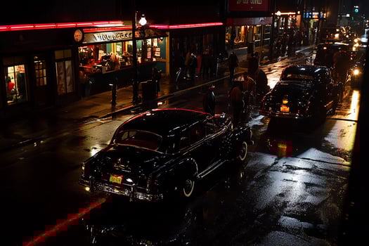 A car driving down a street at night photo