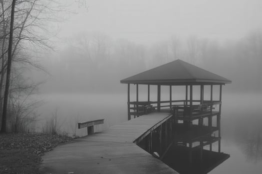 Foggy lake dock and pavilion create serene atmosphere in early morning photo