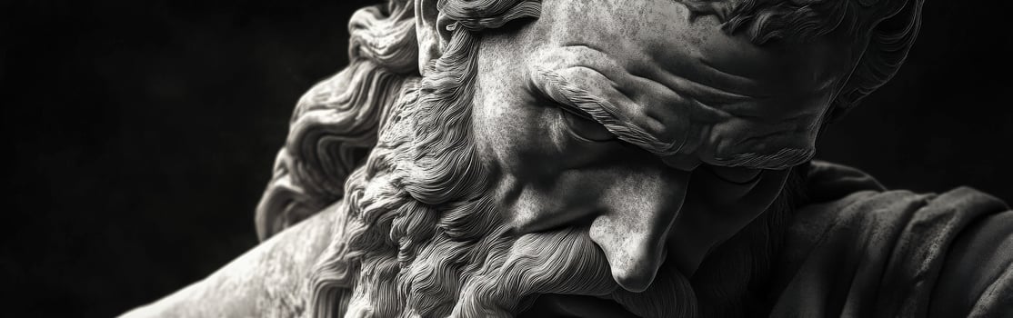 Close-up of a weathered sculpture portraying a thoughtful ancient philosopher photo