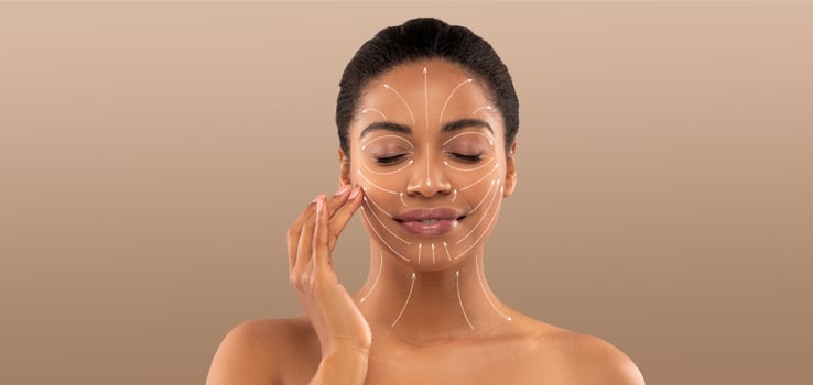 A woman indulges in a skincare routine, applying a facial treatment while enjoying a moment of self-care. Her serene expression highlights the importance of beauty and relaxation. photo