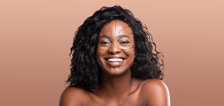 African American woman is enjoying a pampering skincare routine, smiling brightly with a facial treatment designed to enhance her beauty. photo