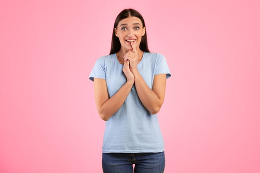 Anticipation And Expectation Concept. Portrait Of Emotional Smiling Young Lady Waiting For Something, Amazed Impressed Woman Looking At Camera, Standing And Posing Over Yellow Studio Background photo