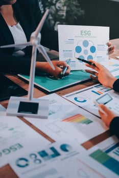 Business people working on a presentation with graphs and papers photo