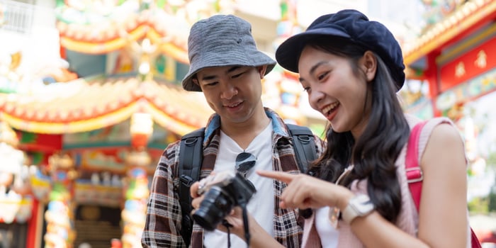 Travel adventures together a couple capturing memories at a colorful cultural festival photo