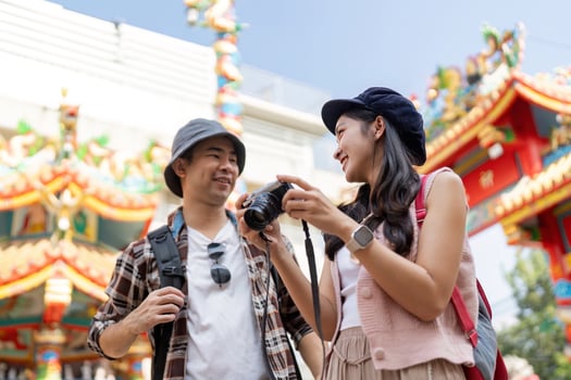 Traveling couple captures moments in colorful cultural environment vibrant festival outdoor viewpoint joyful exploration photo