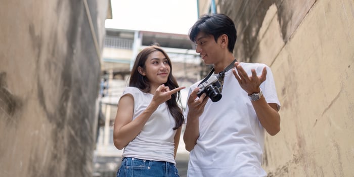 Adventurous travel couple capturing moments in urban alley candid vibrant atmosphere intimate perspective photo