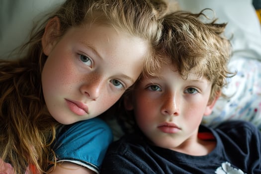 Teenager comforting younger sibling in soft bedroom setting, showing empathy and connection photo