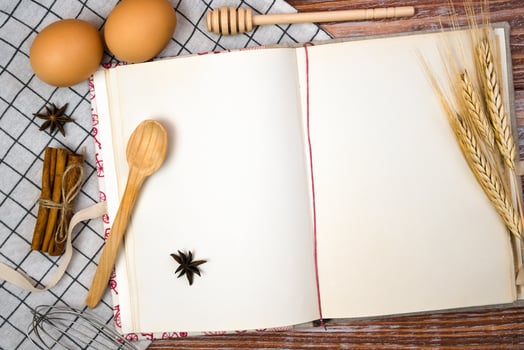 Vintage recipe bookon the kitchen wooden table. Baking and cooking process. Top view. Copy space. photo