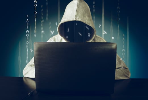 Hacker using laptop. Hacking the Internet photo
