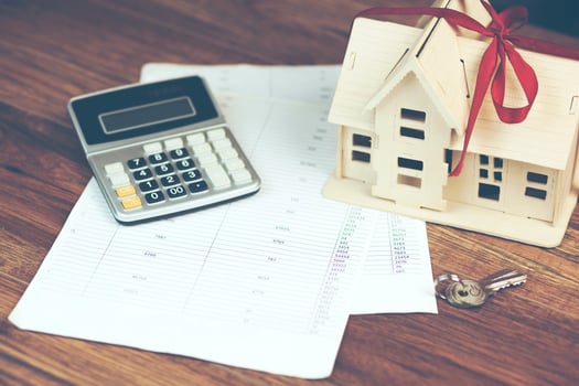 house model with calculator and key on documents photo