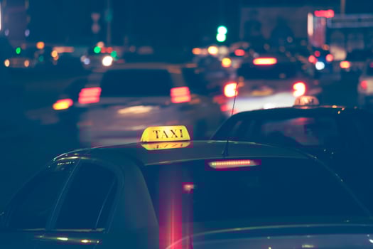 yellow taxi at night in the city photo
