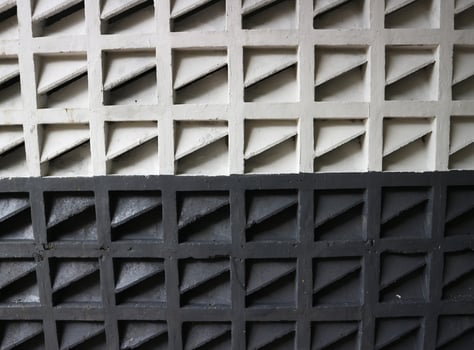a close up of a wall with black and white squares photo