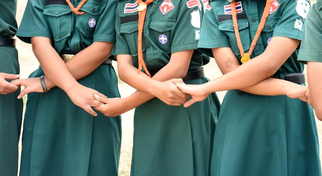 A group of people wearing green shirts and green skirts photo
