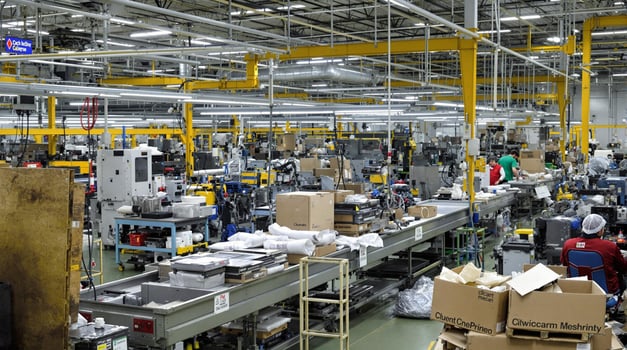 The Industrial Manufacturing Floor is busy with machinery and workers contributing to production photo