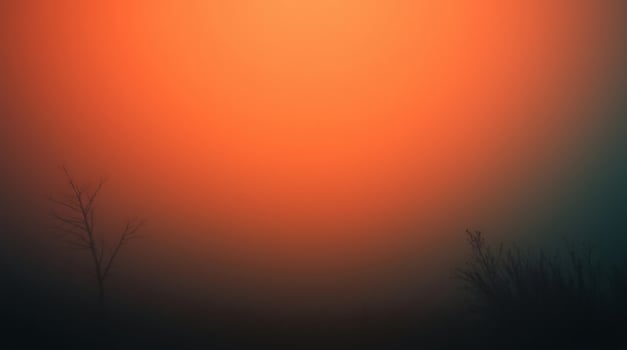 A silhouette of a tree in the fog with orange light photo