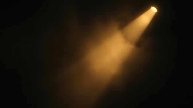 A spotlight shines on a dark background photo