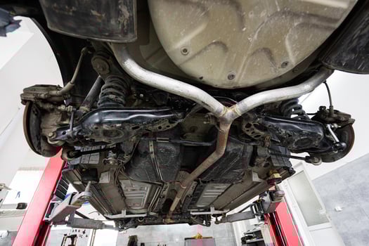 Car underside view in a modern auto repair shop photo