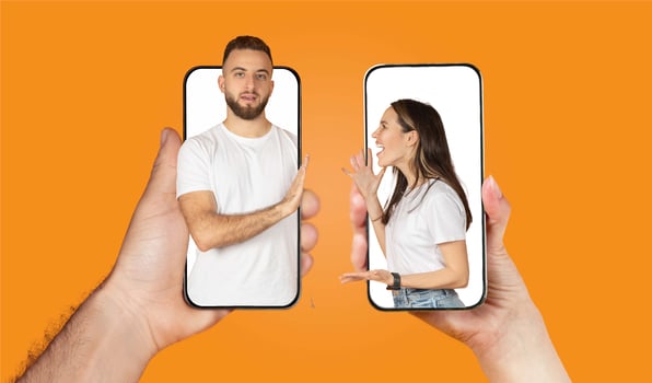A couple interacts through their smartphones, showcasing the modern way of staying connected. Their expressions reflect the love and affection they share, even while apart. photo