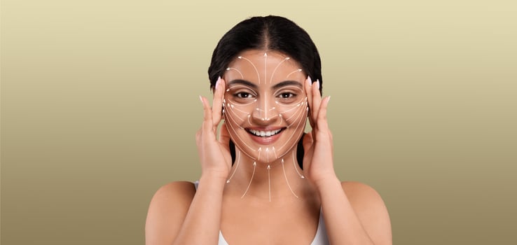 Indian woman enjoys her skin care routine, pampering herself with a facial treatment. She gently places her hands on her face, embracing relaxation in a serene, isolated setting. photo