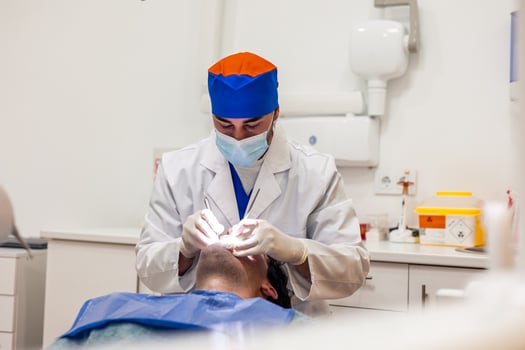 Dentist performing dental checkup on patient in modern clinic photo