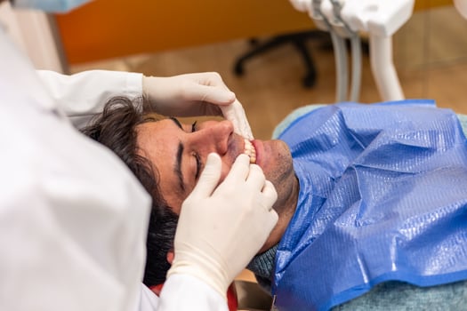 Dentist examining patient's teeth in dental clinic photo