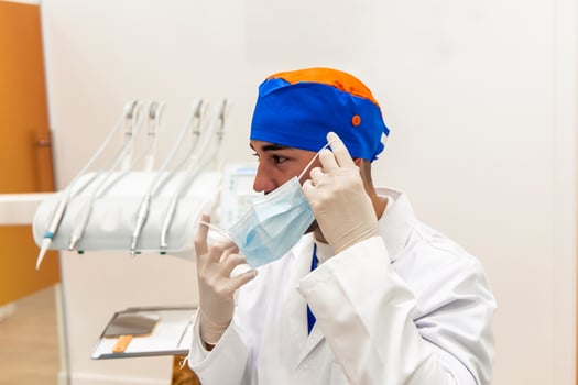 Dentist wearing surgical mask and gloves in dental clinic photo