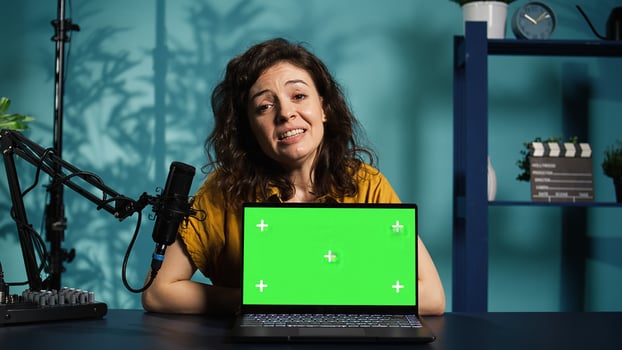 Online show host being sponsored by partnering brand to do isolated screen laptop unboxing content. Tech expert does influencer marketing, doing chroma key notebook product placement, camera B photo