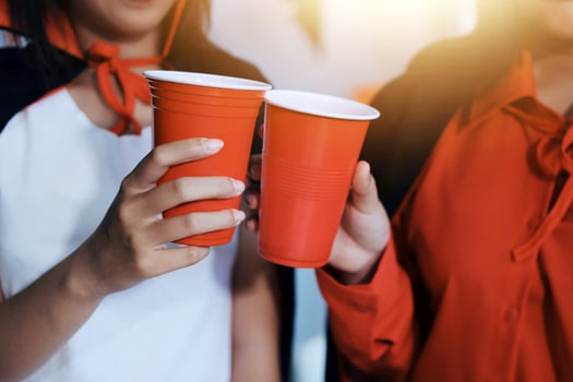 Two women in halloween costumes holding red cups photo