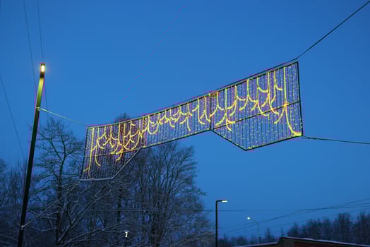 The enchanting display of Winter Holiday Lights twinkles vibrantly against a clear blue sky photo