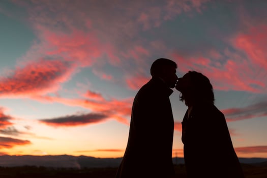 Kissing under stunning red sky photo