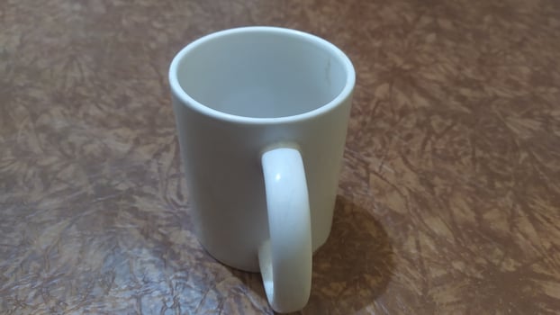 a white mug sitting on a table photo