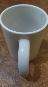 a white coffee cup with a handle on it photo