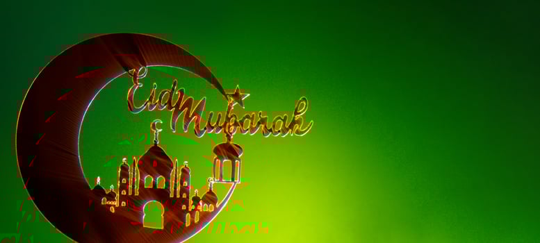 Crescent moon at top of mosque. Eid Mubarak text creative conceptual poster design for advertising branding. Mock up template for greeting card postcard. Ramadan Kareem background. Traditional muslim holiday. Copy space photo