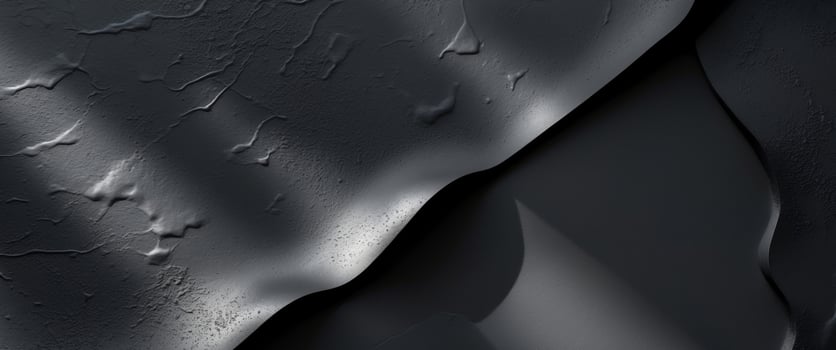 Textured black surface with subtle variations in light and shadowTextured black surface with subtle variations in light and shadow. photo