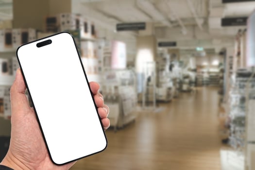 Mockup blank screen mobile phone for app or web site mockup. Smart phone with white screen in hand on Blur furniture store photo