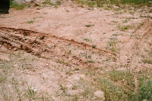 Tire tracks left by a car on a dirt road, photo