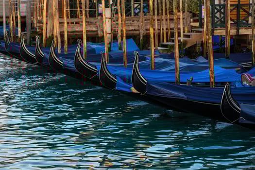 Blue gondolas in Venice, Italy at sunrise. Detail shot photo