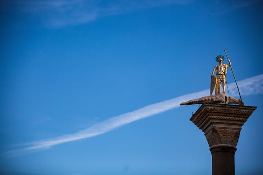A statue of a man on top of a pillar photo